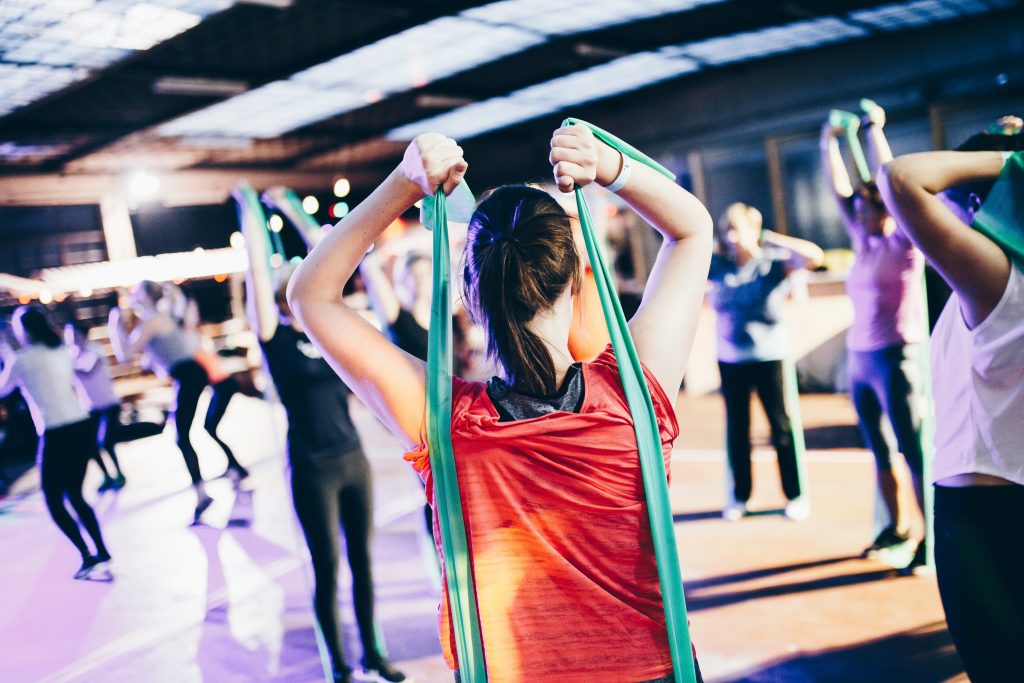 Image of a group of people exercising with resistance rubber bands.