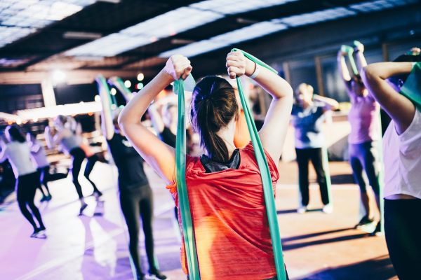 Image of a group of people exercising with resistance rubber bands.