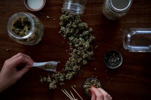 Image of a person rolling a marijuana joint.