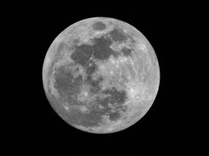 High-resolution view of the full Moon with visible surface features including dark maria and bright crater rays.