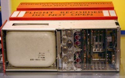 Open orange flight recorder showing the memory unit and circuit boards.